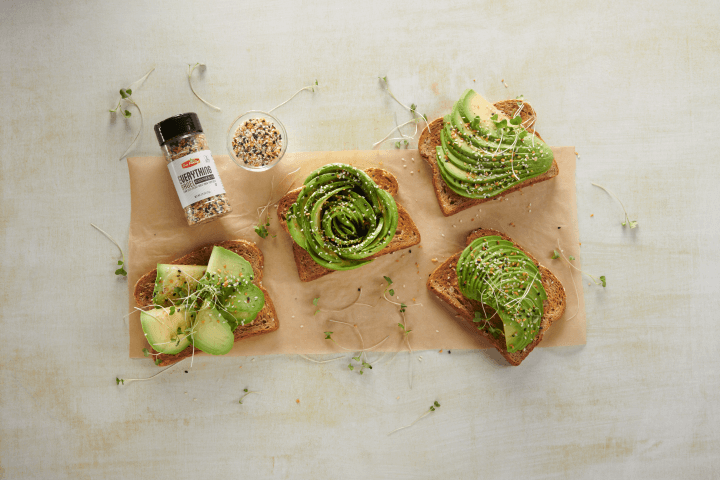avocado toast topped with everything bagel seasoning on a wooden board