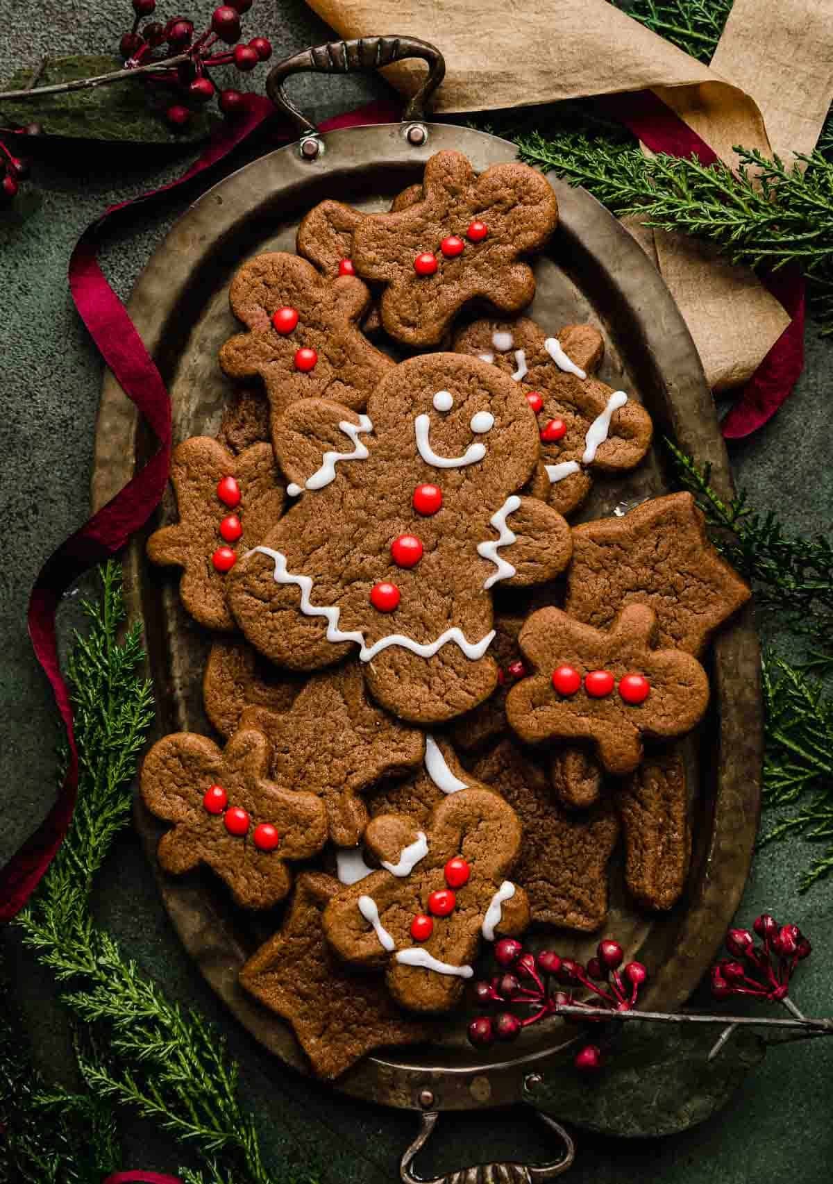 plate of freshly baked gingerbread cookies with icing, soft centers, and spicy edges, festive background
