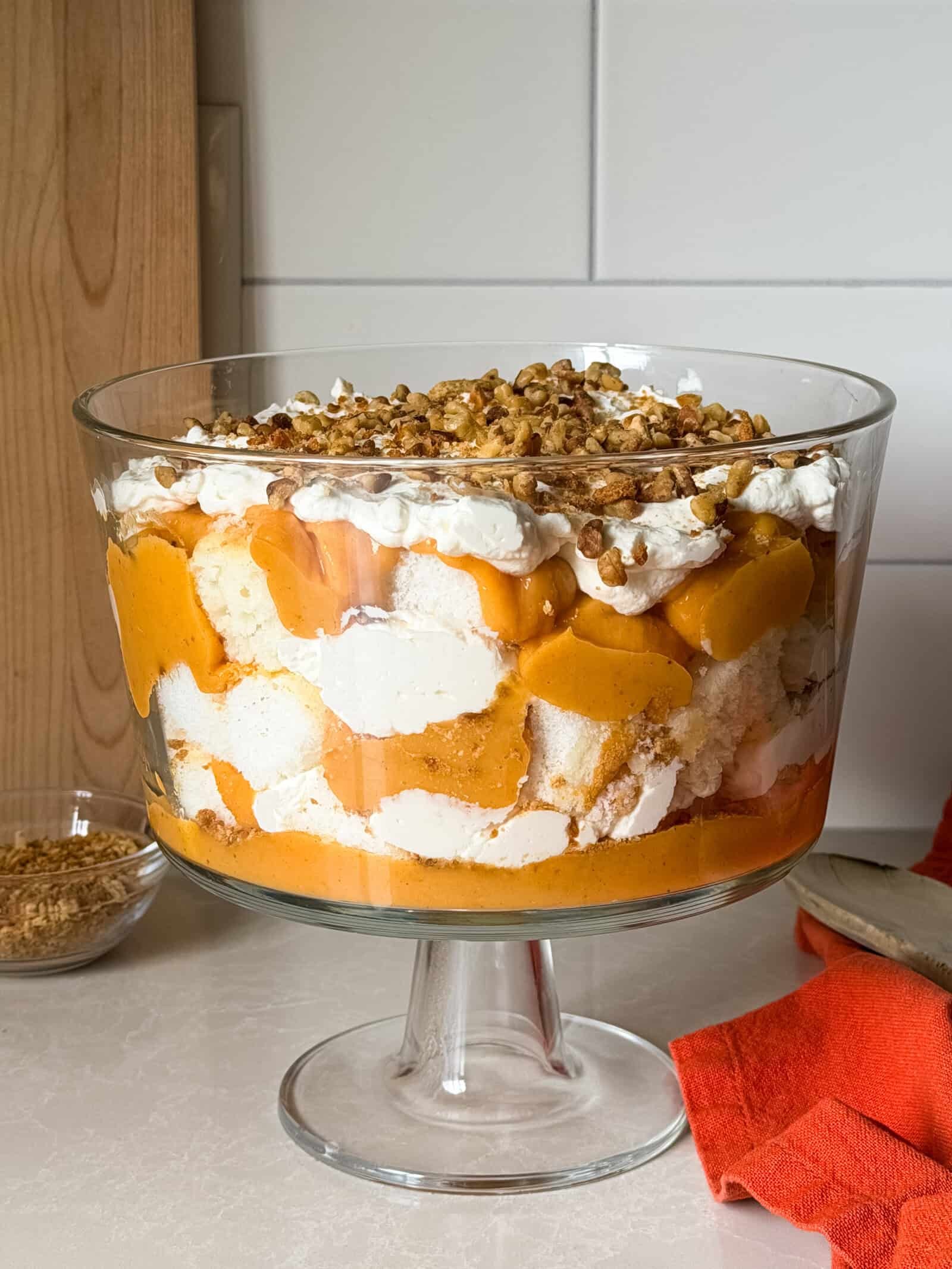 pumpkin trifle dessert with layers of cake, cream, and pumpkin puree