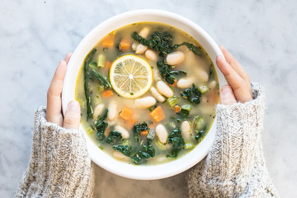 bowl of lemony white bean soup with kale