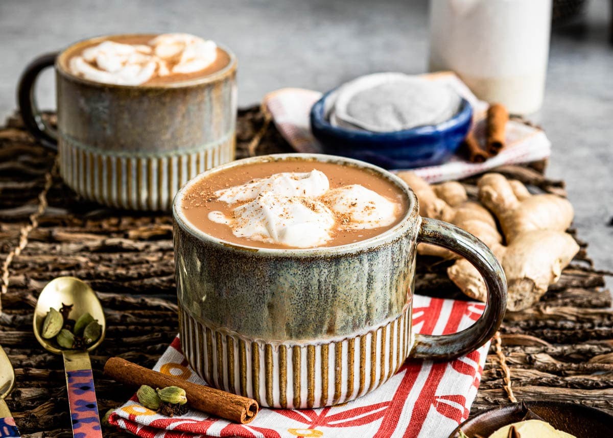 warm maple cinnamon oat chai drink in a cozy setting