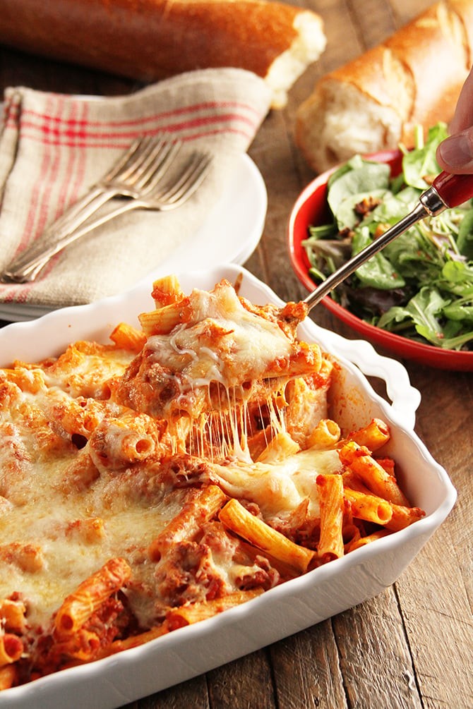 Hearty cheesy baked ziti casserole fresh from oven, with steam rising