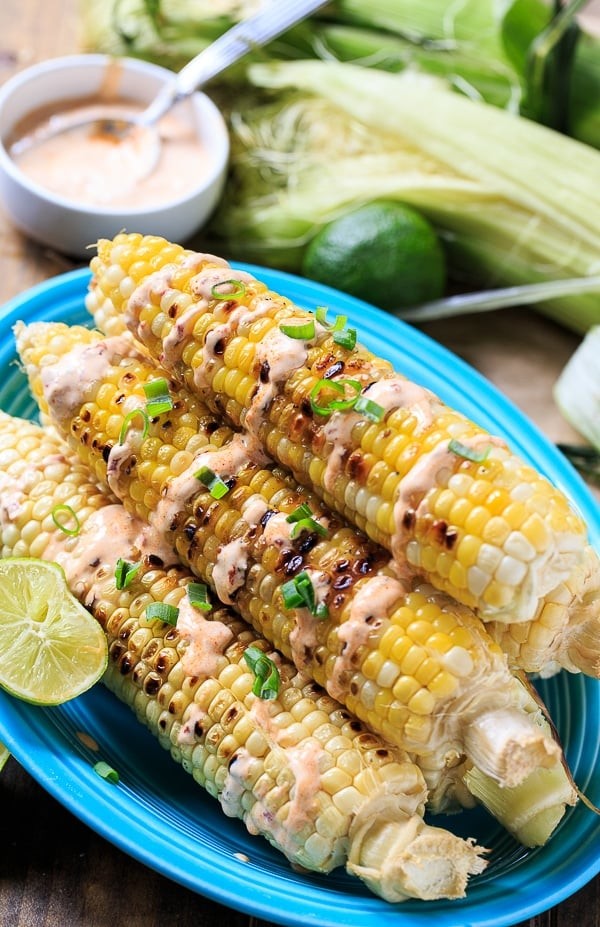 grilled corn on the cob with chipotle-lime crema drizzled on top