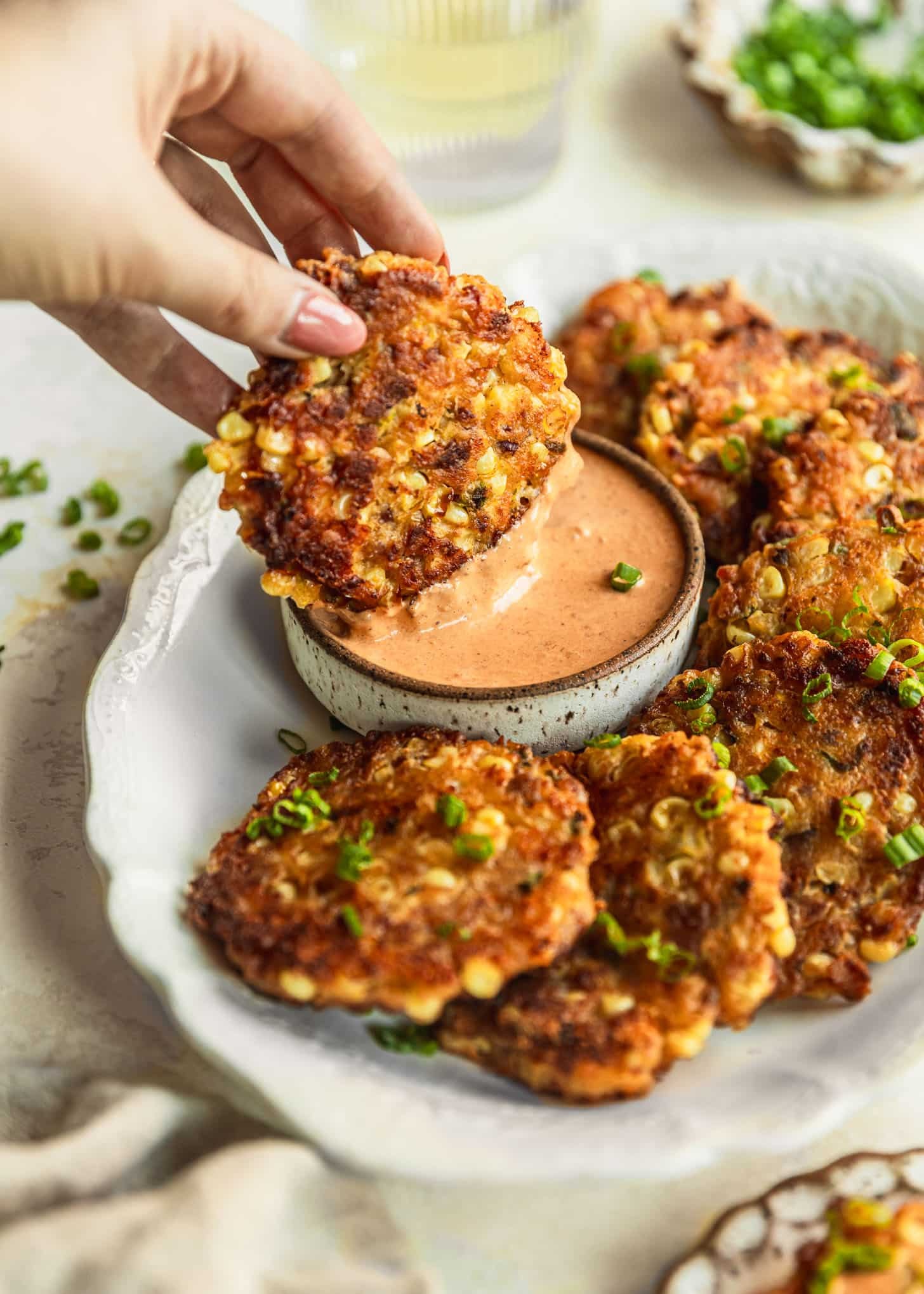 grilled corn fritters with chipotle mayo being served