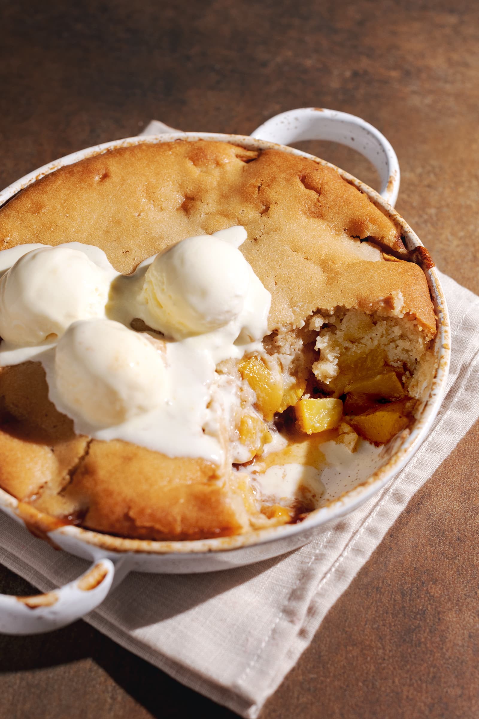 Thyme infused peach cobbler with a scoop of vanilla ice cream