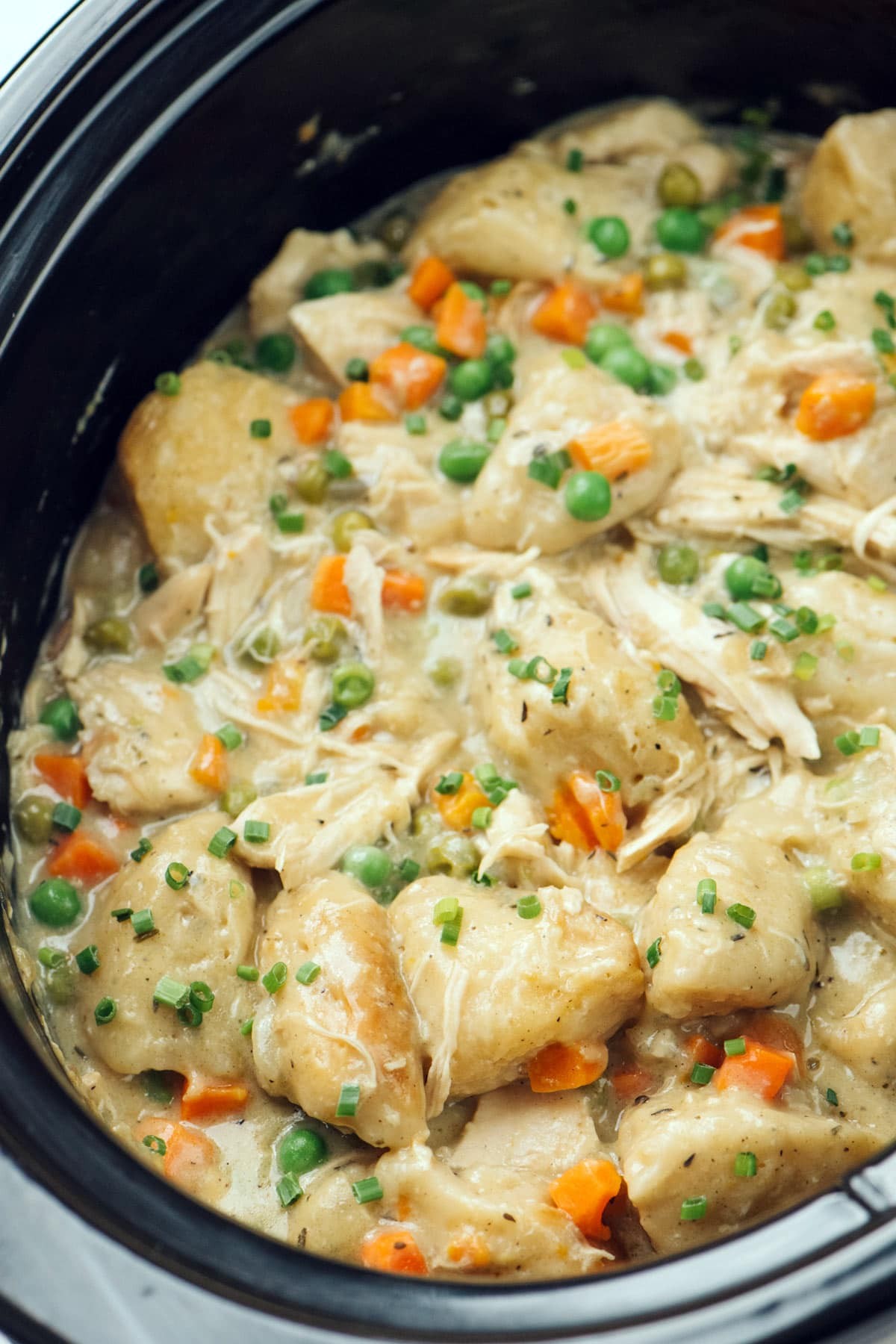close up of creamy chicken and dumplings in a crockpot
