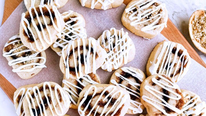 Delicious homemade cinnamon sugar pinwheel cookies cooling on a wire rack, close up, warm lighting, cozy kitchen scene