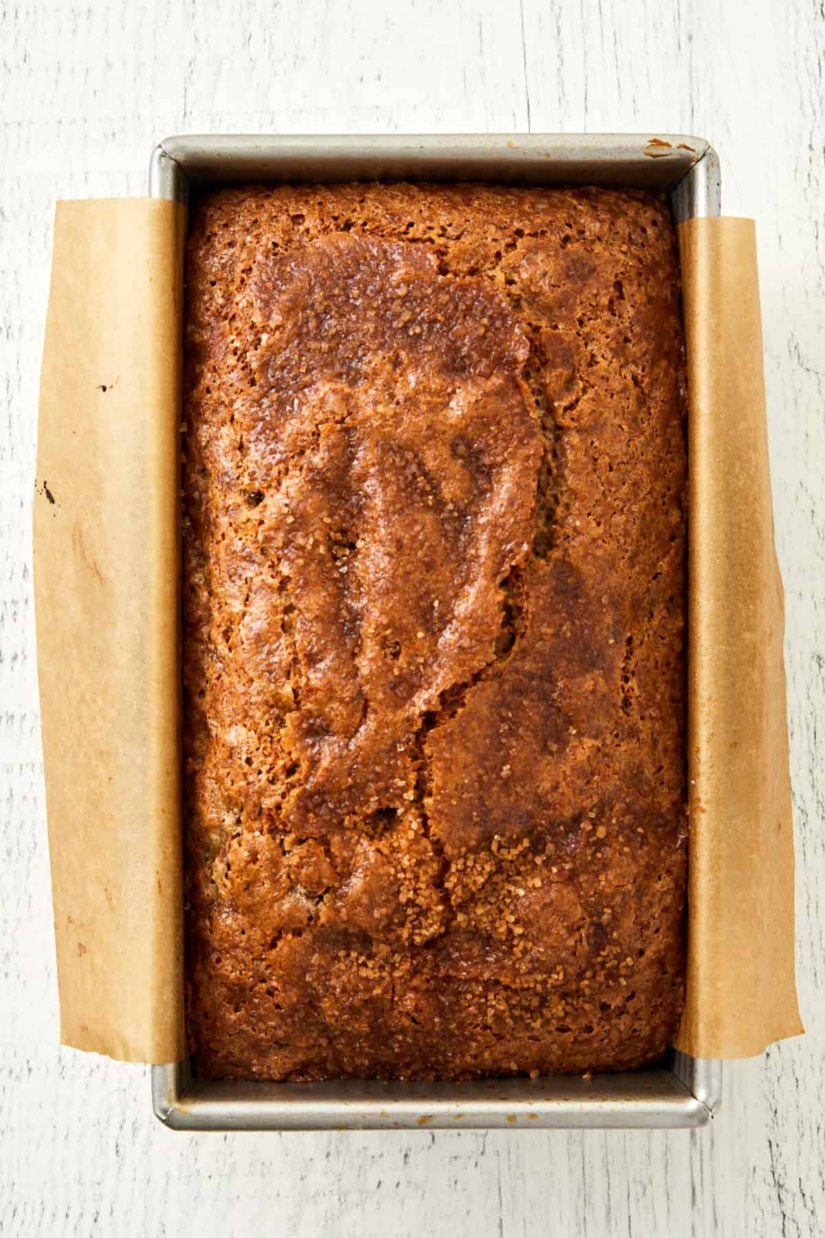 a loaf of rhubarb banana bread cooling on a wire rack
