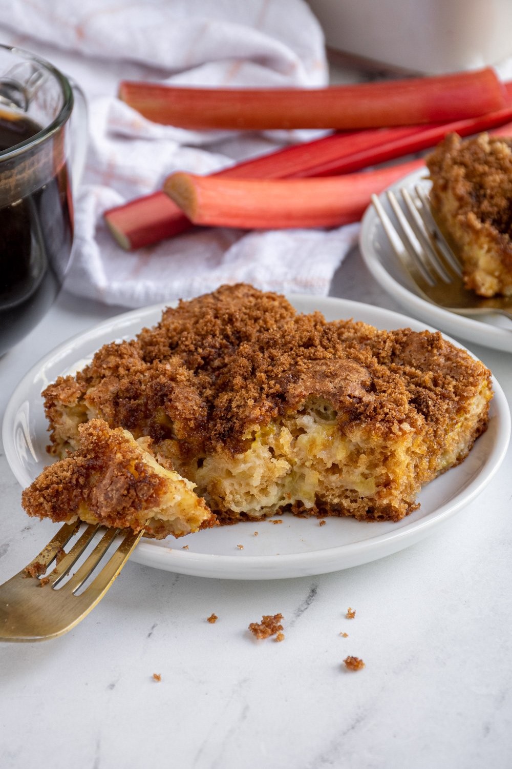 slice of rhubarb and yogurt cake with a cup of coffee