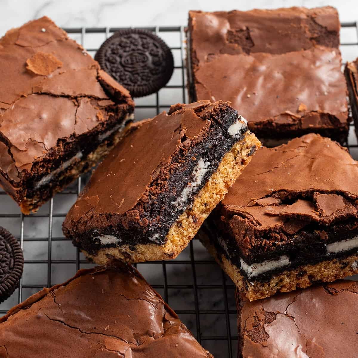 close up shot of gooey chocolate brownie cookie bars on a cooling rack, rich chocolate and chewy texture visible