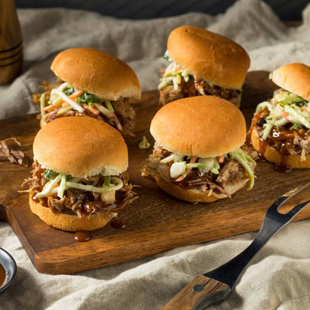 ghost pepper pulled pork sliders on a wooden board