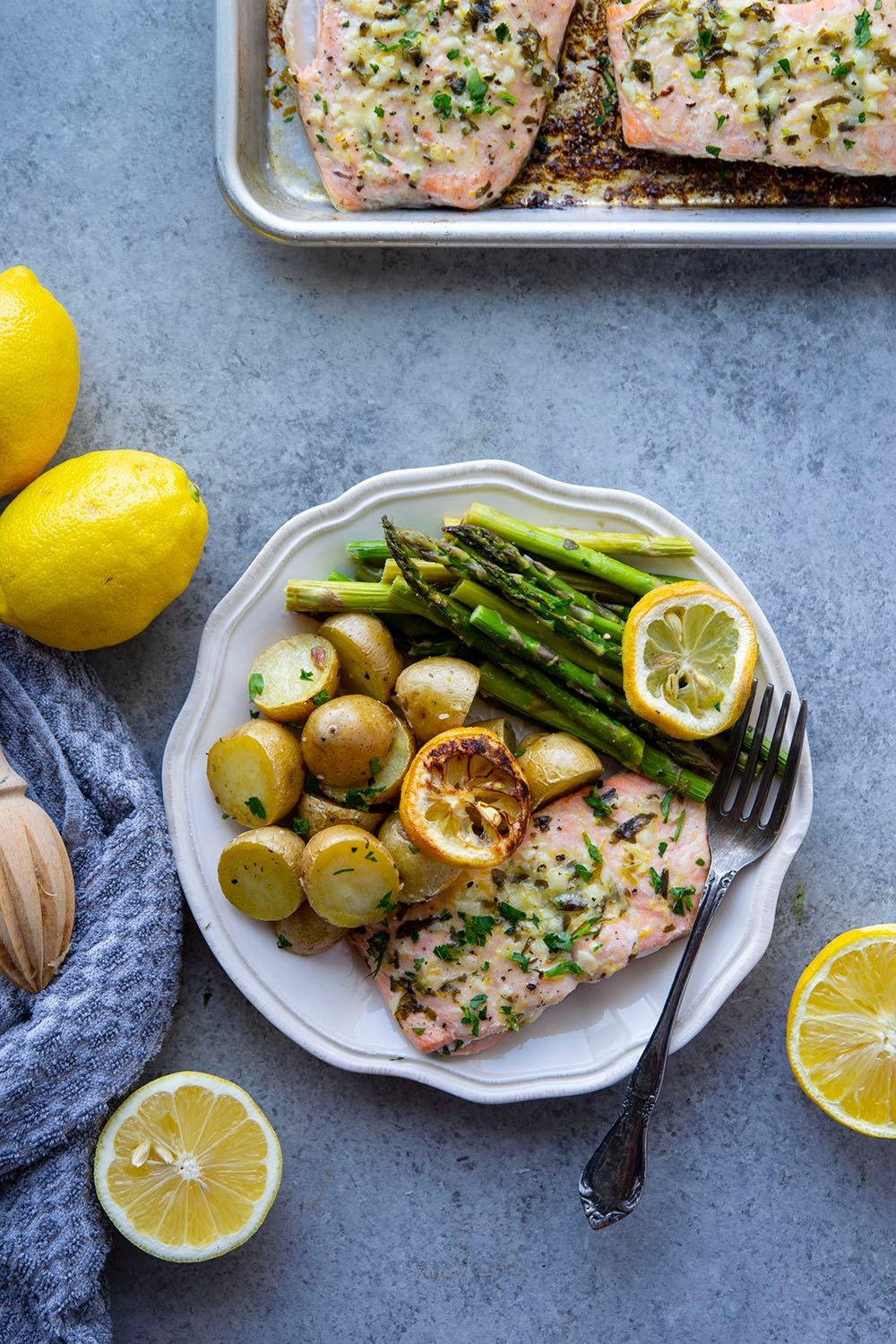 beautifully plated lemon garlic salmon with asparagus and fresh herbs