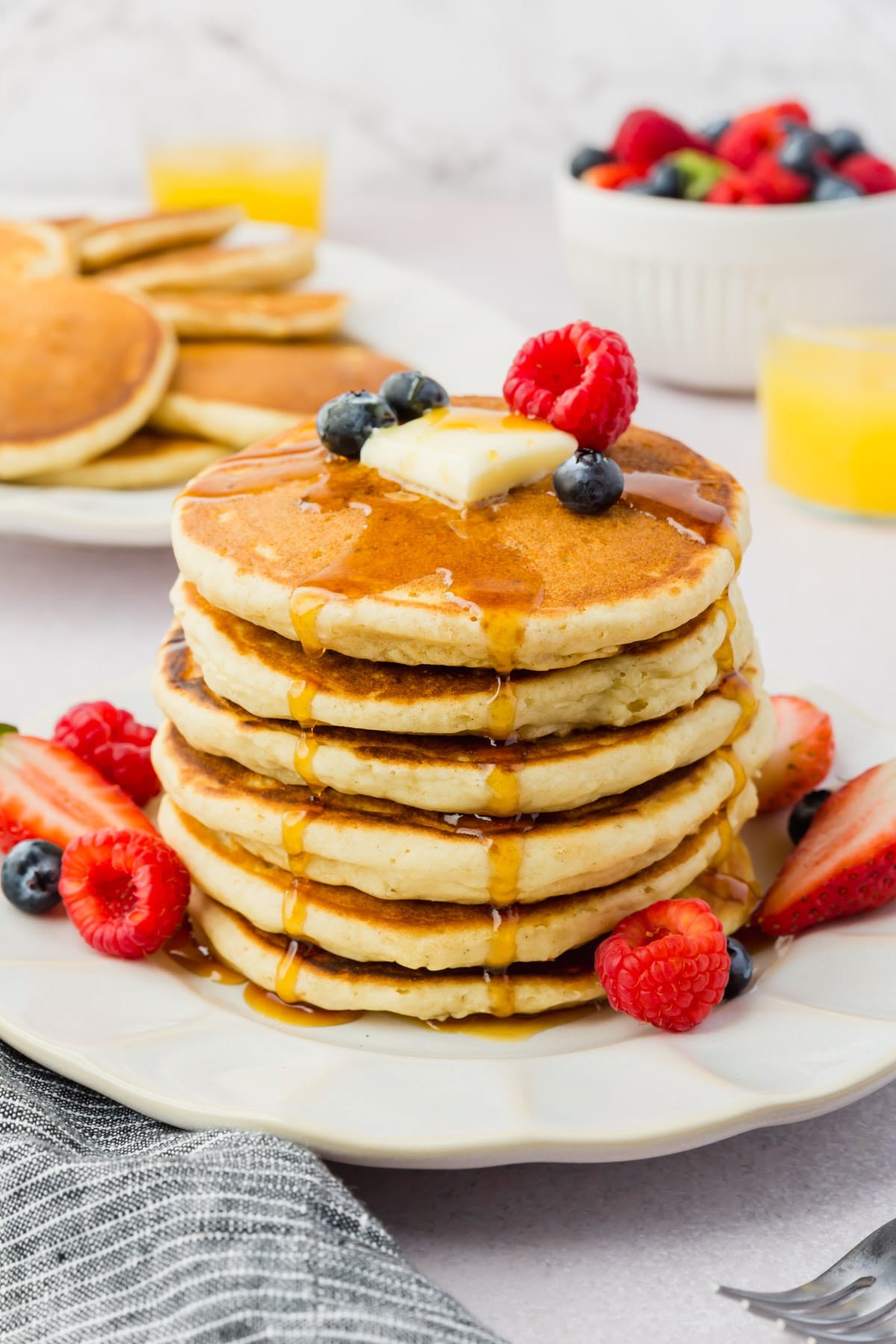 stack of gluten-free Canadian pancakes with maple syrup and berries
