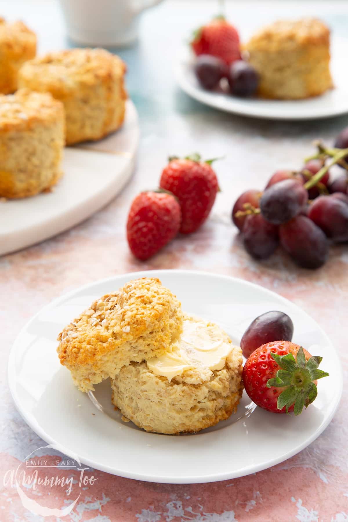 freshly baked strawberry oat and dried apricot scones on a wooden board
