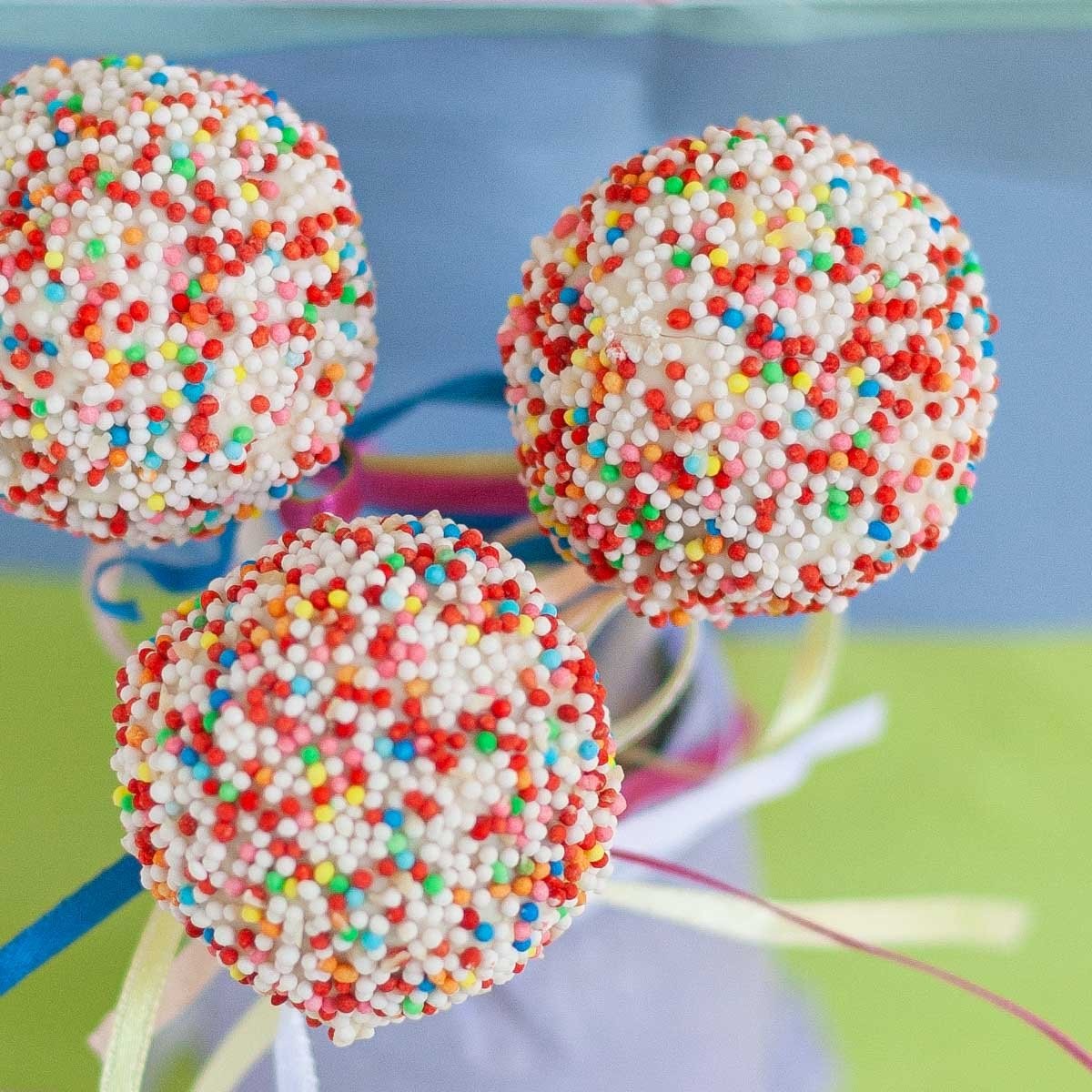 Kringle cake pops decorated with icing and sprinkles