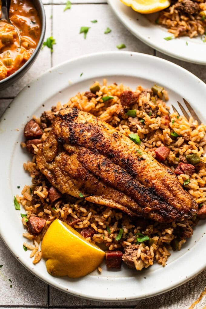 blackened catfish plated with dirty rice and creole butter