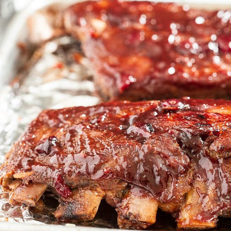 close-up of cranberry orange BBQ ribs on a grill