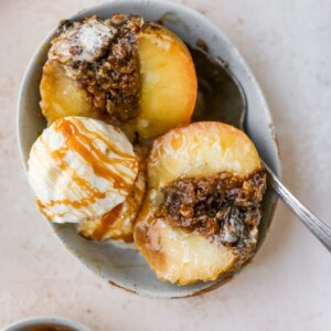 close up shot of apple cider baked apples with ice cream and cinnamon