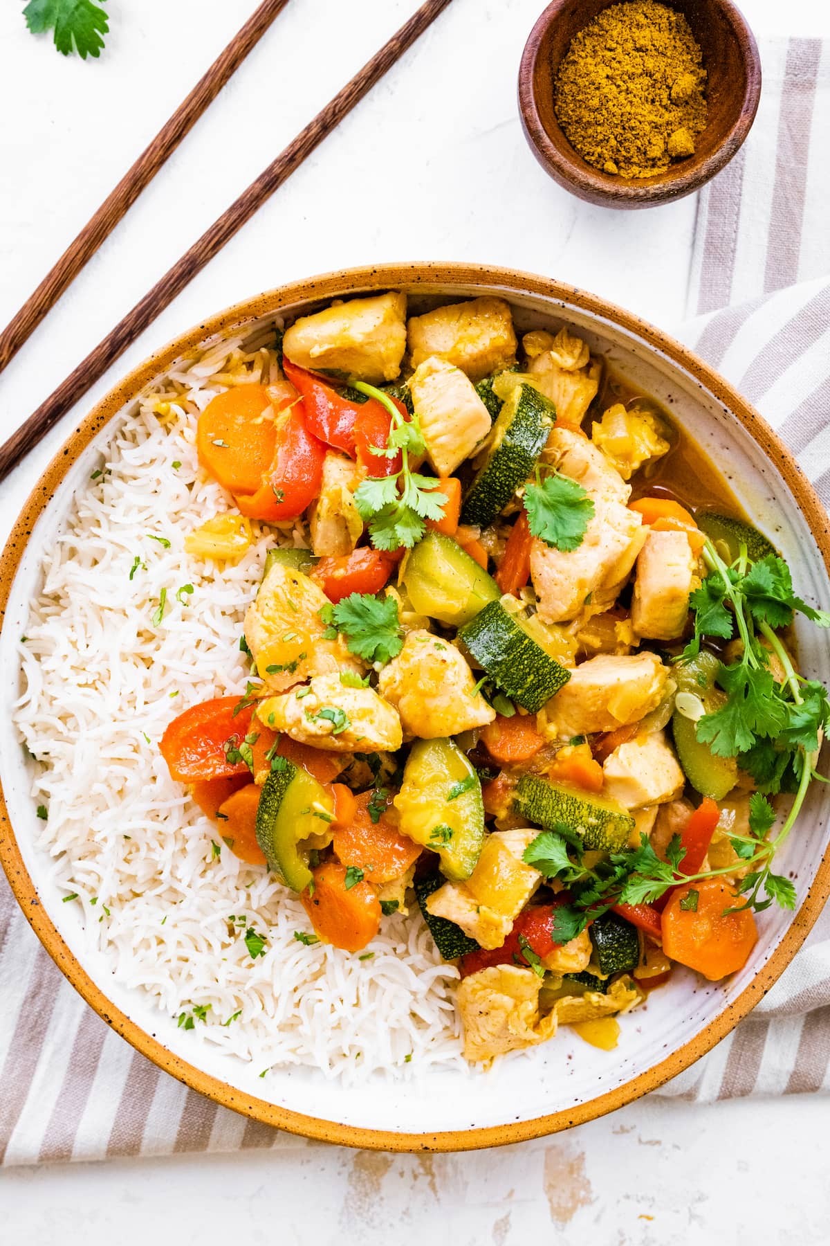 grilled chicken and vegetable curry with coconut milk served in a bowl