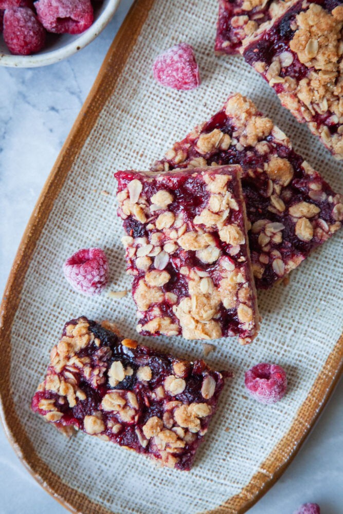 rye raspberry bars on a wooden cutting board