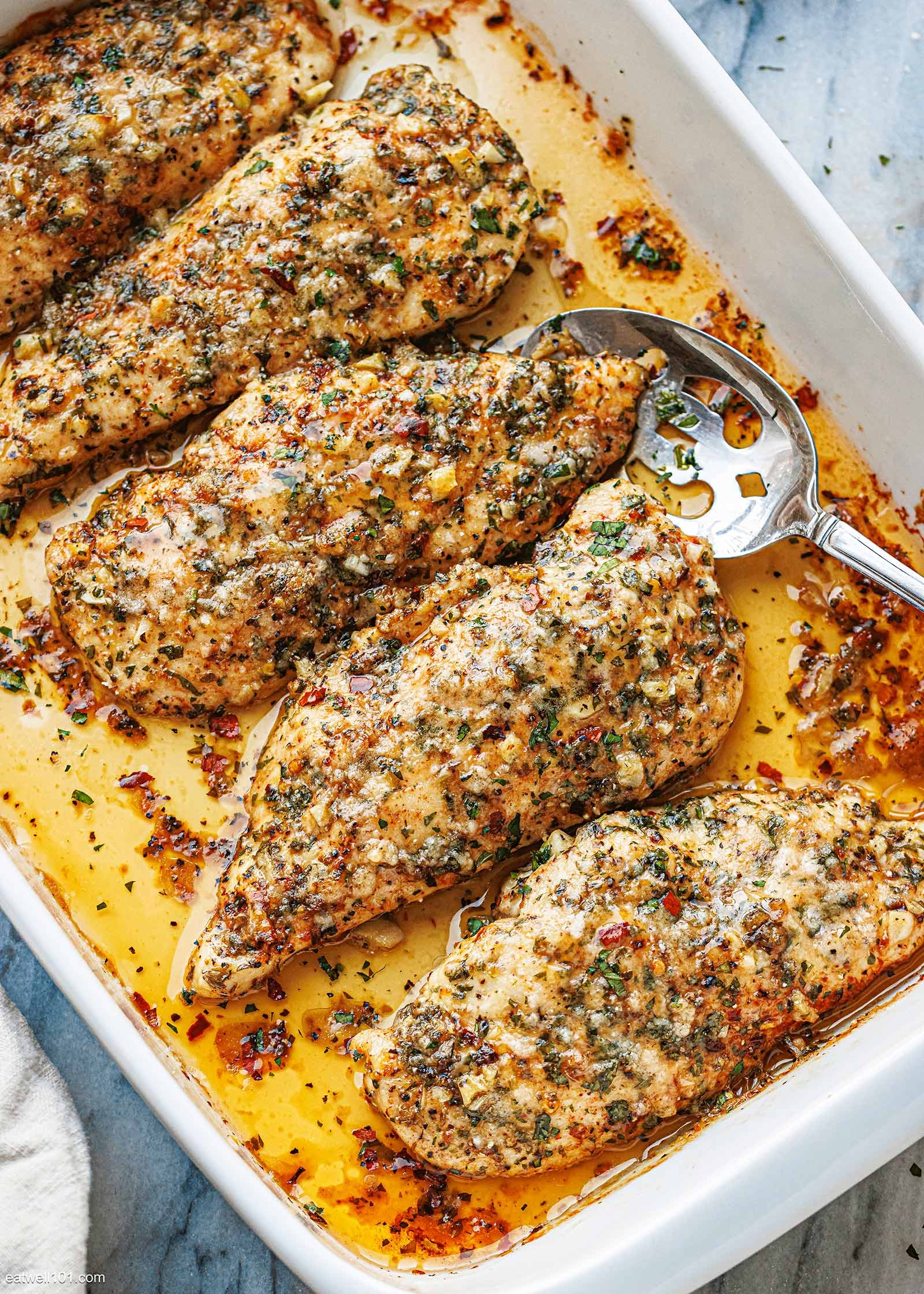 Garlic Parmesan Baked Chicken Breasts, golden brown, with fresh parsley garnish
