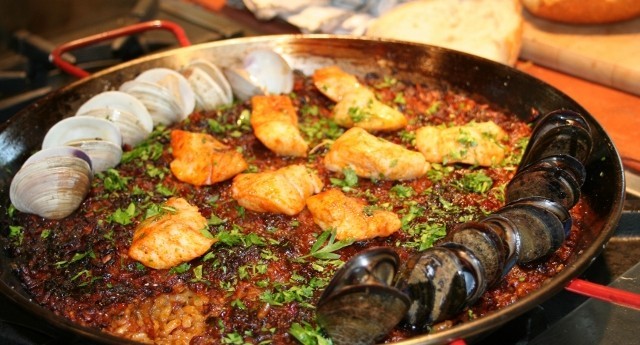 paella baked apples with saffron rice on a rustic wooden table