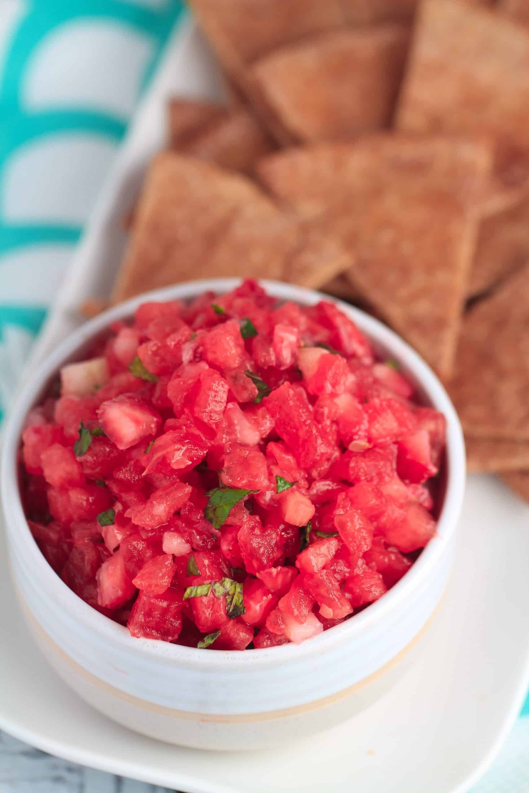 fresh watermelon salsa with cinnamon chips on a rustic wooden table
