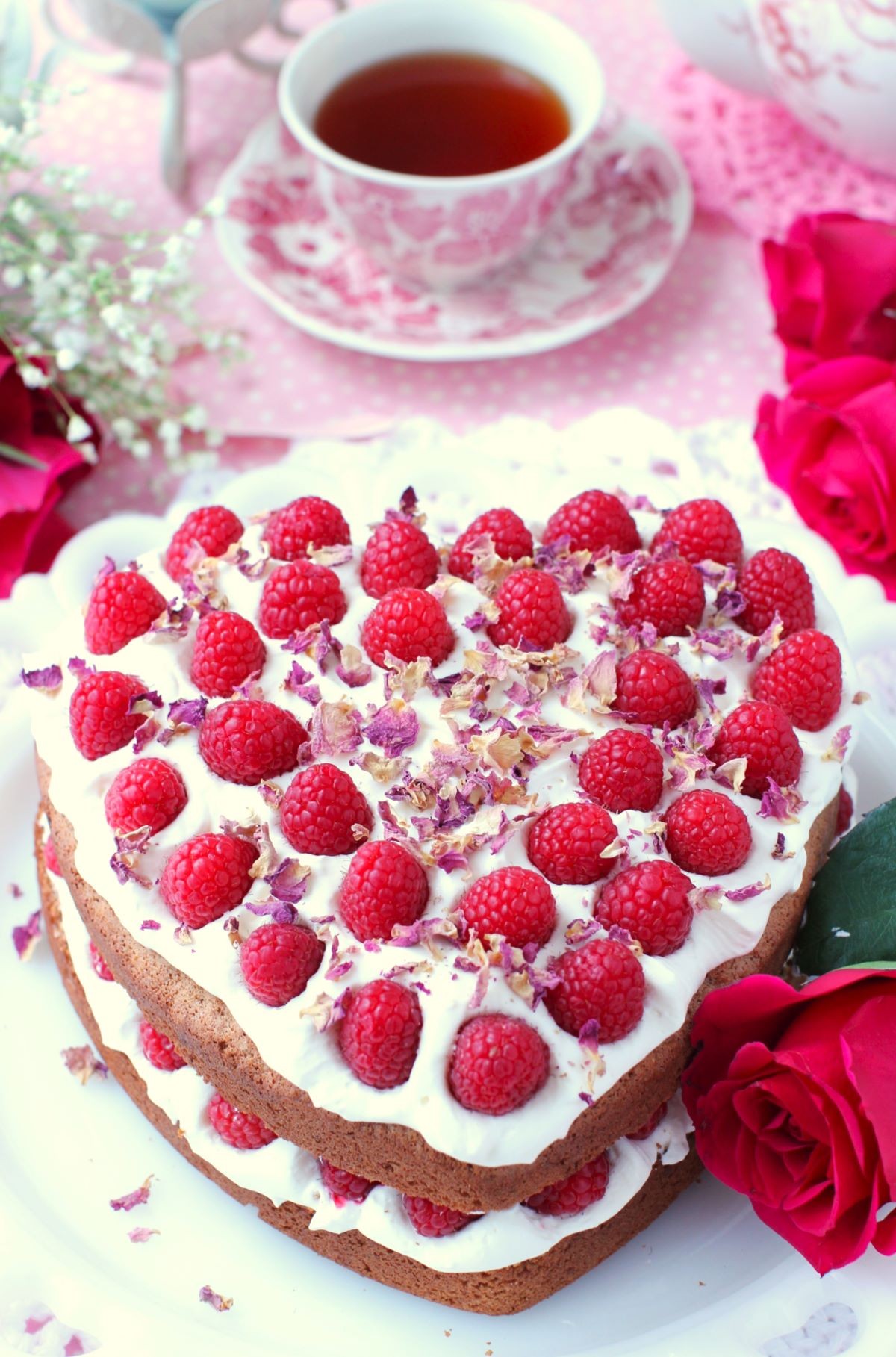 Valentine's Raspberry Rose Cheesecake with fresh raspberries and rose petals