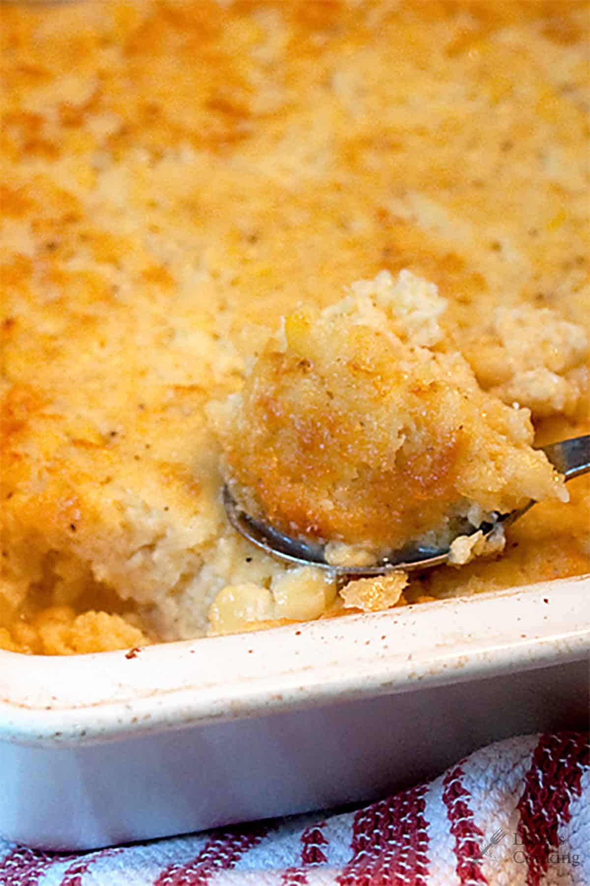 Deliciously golden brown sweet corn casserole in a baking dish, ready to serve