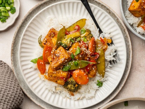 a vibrant teriyaki tofu tower stir-fry served on a plate