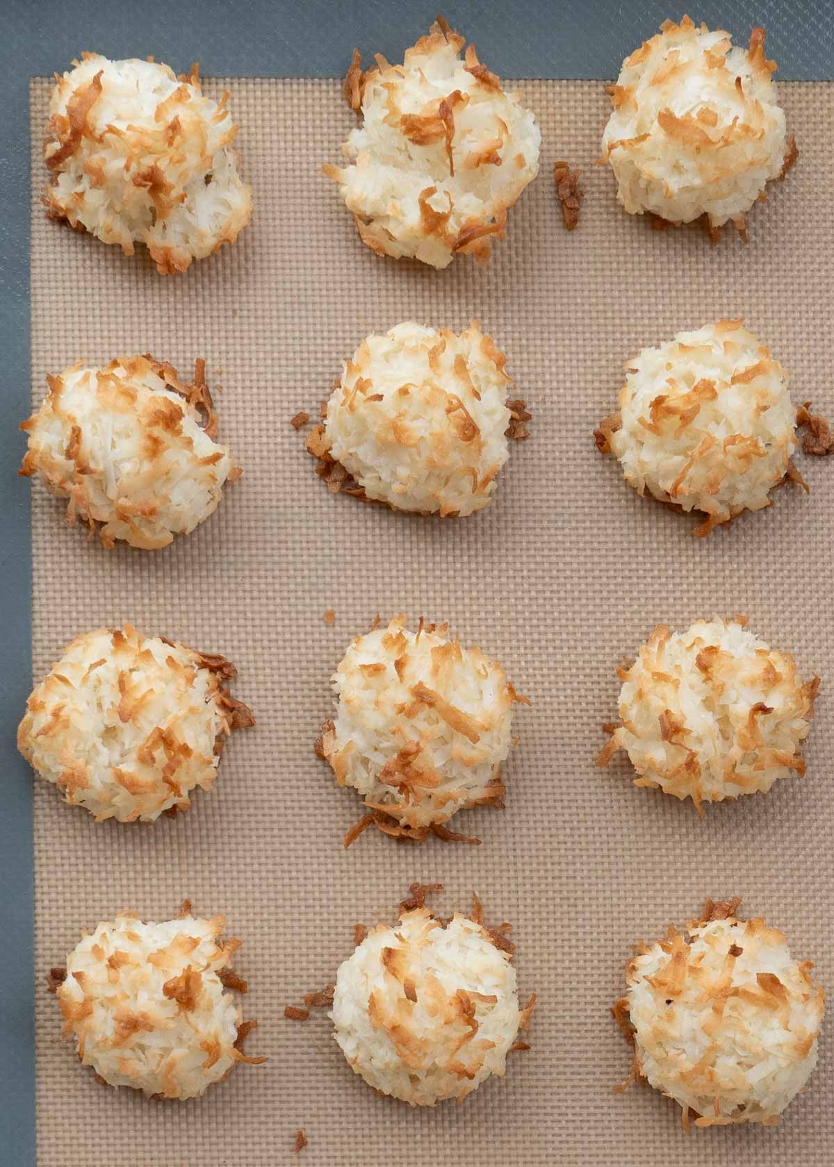 overhead shot of coconut almond macaroons on a baking sheet