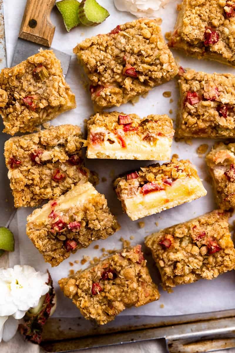 cinnamon rhubarb crumb bars on a rustic wooden surface