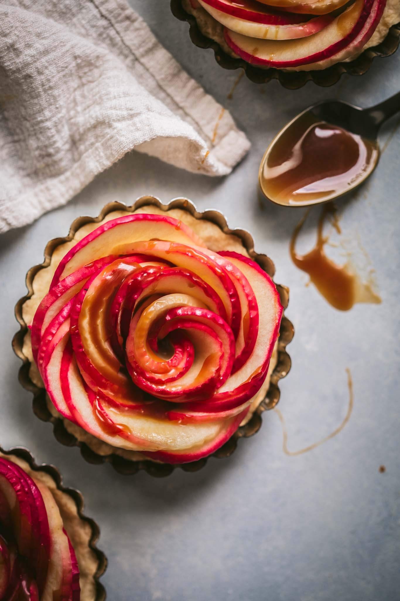 overhead shot of a beautifully arranged salted caramel apple rose tart