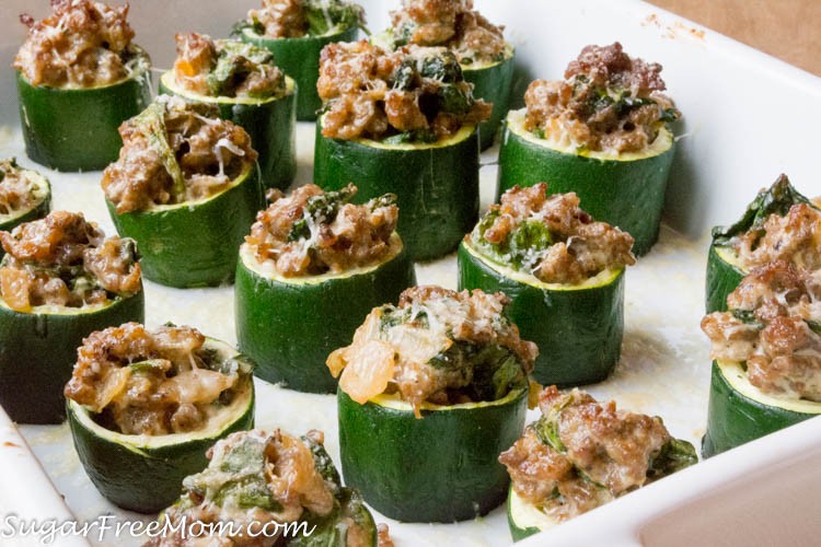 Italian sausage and spinach zucchini cups on a rustic wooden table