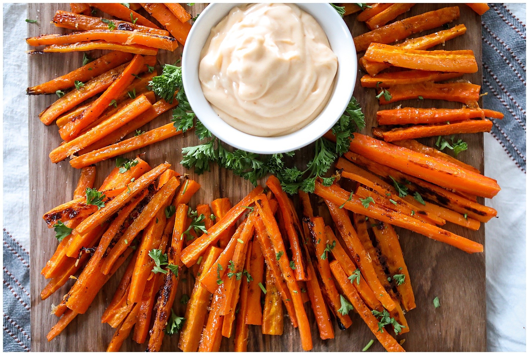 Date Syrup Glazed Carrot Fries on a wooden board
