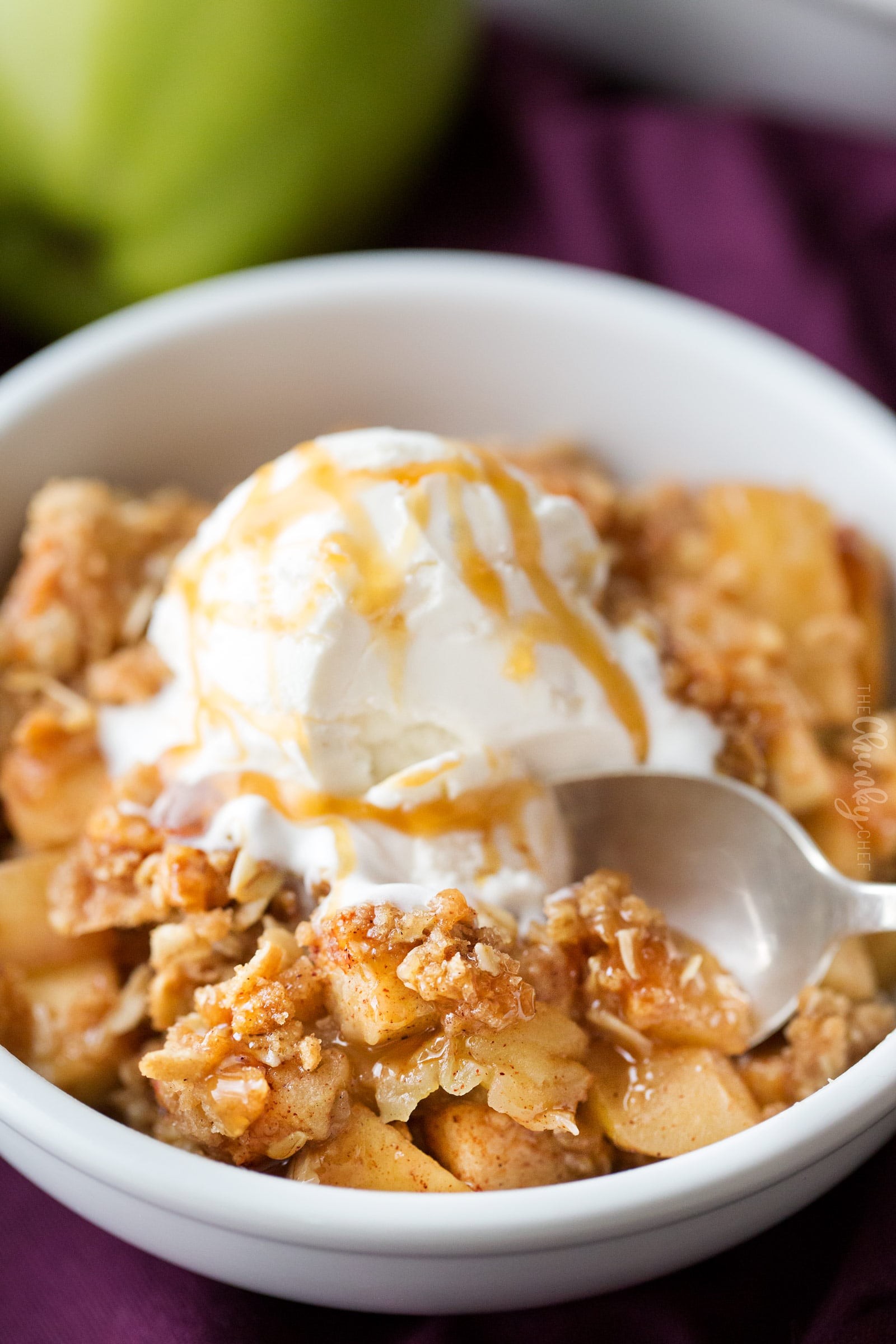 golden brown apple crisp with a scoop of vanilla ice cream