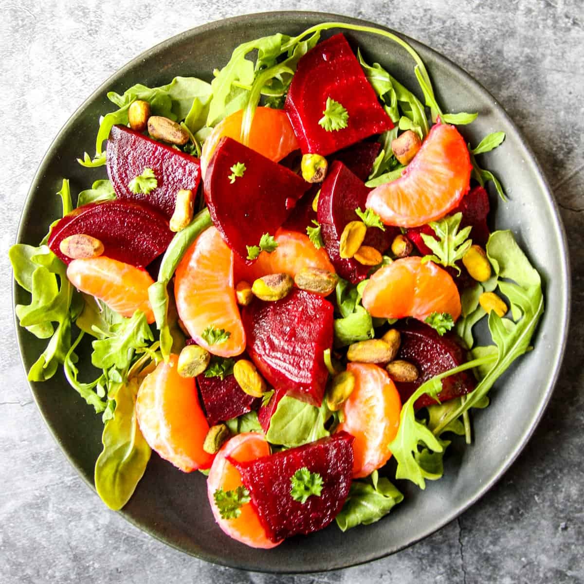 Vibrant roasted beet salad with orange slices and feta cheese, bright lighting