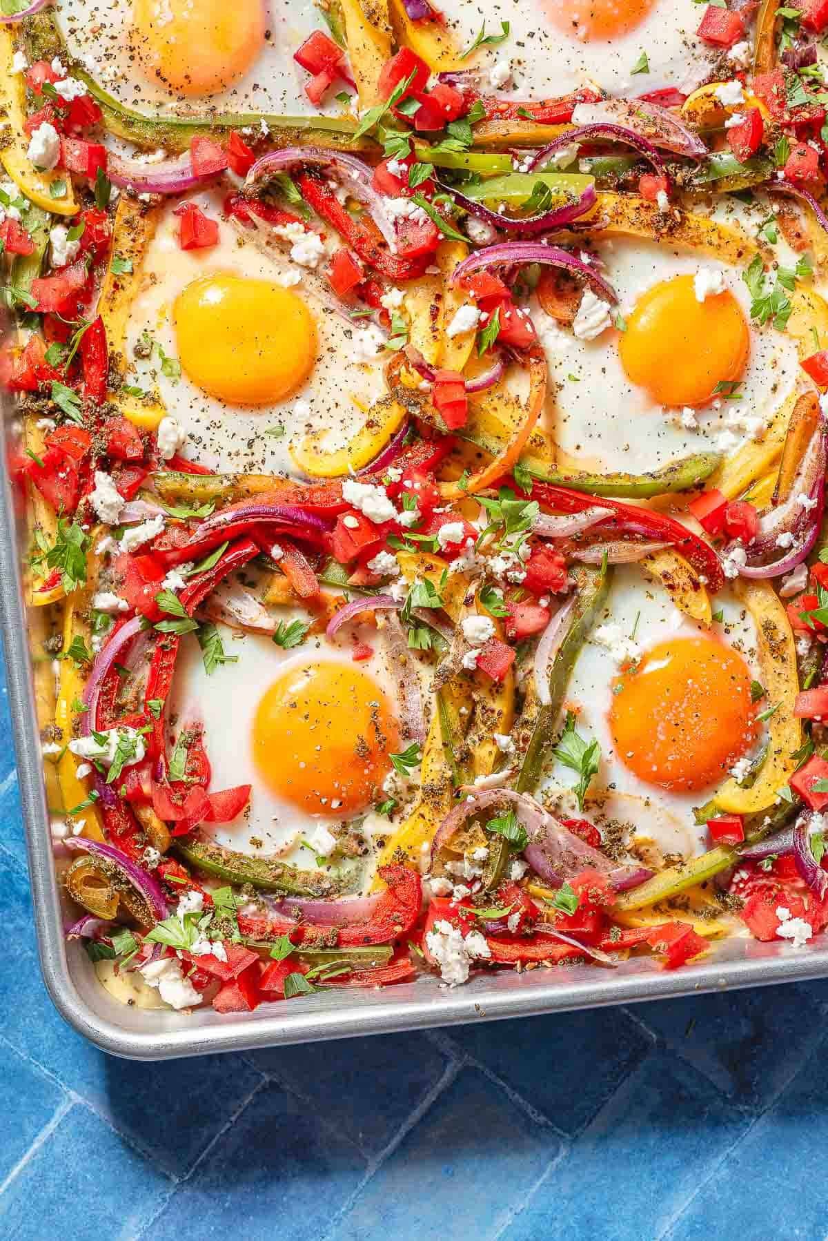 vibrant sheet-pan breakfast with eggs, sausage, and colorful vegetables, bright morning light