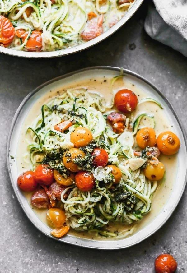 zucchini noodles with burst cherry tomatoes and basil