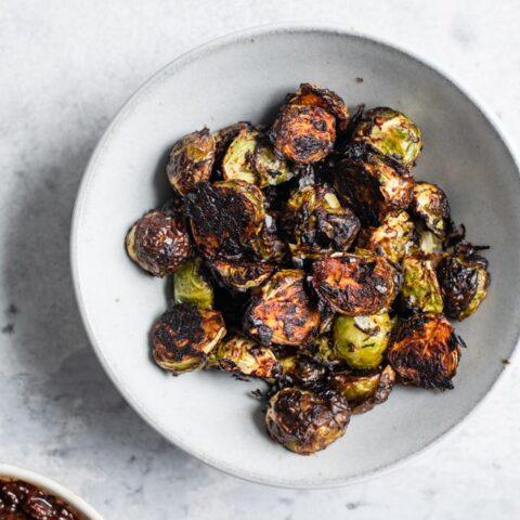 roasted brussels sprouts with chickpeas and harissa on a plate